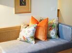 Morgenduft double room with a grey sofa and colourful cushions.